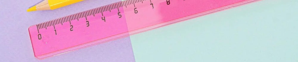 A desk ruler and the end of a pencil